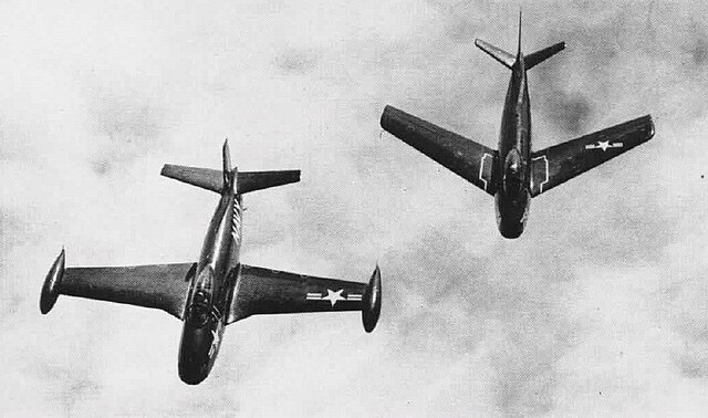 A straight-winged North American FJ-1 flying next to a swept-wing FJ-2 in 1952.