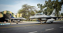 US F-16 from the 15th AF exits it's hangar while a Pakistani F-16B from No. 9 Squadron PAF taxis to the runway during Exercise Falcon Talon 2022 Falcon Talon 2022 US and Pakistani F-16.jpg