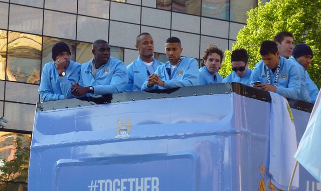 Hargreaves (centre) on an open-top bus victory parade after Manchester City won the Premier League, 2012