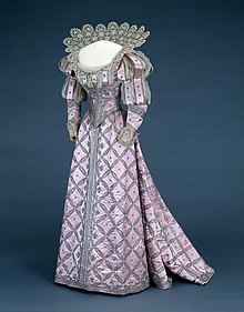 Historical pink evening dress with stiff, high lace collar and decorated with silver and brilliants