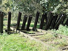 A replica of the "asparagus" barricade that was used to derail the German train. Mill Rijksmonument 509273 aspergeversperring op spoordijk oost van Defensiekanaal.JPG