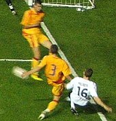 Milner (right) playing for the England under-21 team Milnercross.jpg