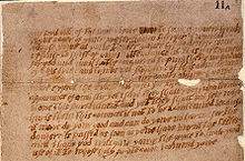 A damaged and aged piece of paper, or parchment, with multiple lines of handwritten English text.