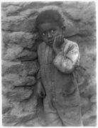 Negro child against stone wall