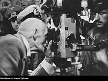 The 84-year-old, Nazi-friendly Norwegian author Knut Hamsun, who received the Nobel Prize in Literature in 1920, peers through the periscope aboard the U-479 submarine in Arendal, Norway, during a propaganda visit in June 1944. Norwegian writer Knut Hamsun peers through a periscope aboard WWII Kriegsmarine submarine U 479 in Arendal, German-occupied Norway 1944-06-27 Nazi war propaganda Narodowe Archiwum Cyfrowe 3 2 0 - 16208 191406 Public domain.jpg