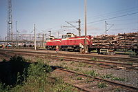 Two diesel locomotives (class Dv12) transporting wood at the Oulu train station freight yard.
