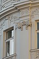 {{QICpromoted Facade details at the curved frontside of the Palais Herberstein at northwest corner of Michaelerplatz, Vienna.