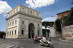 A scooter passes by in front of Porta San Pancrazio in Monte Gianicolo, Rome, Italy