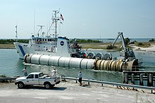 The rocket booster recovery ship Freedom Star with a spent solid rocket booster (SRB) from the STS-114 launch in tow as it makes its way through Port Canaveral. STS-114 booster recovery.jpg