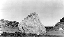 Concrete block from the west abutment of the dam about half a mile below the dam site. Approximately 63 ft. long, 30 ft. high and 54 ft. wide (19.2 m x 9.1 m x 16.5 m). The wing wall is in the distance. St. Francis abutment.jpg