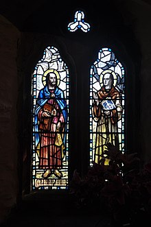 A stained glass window in the chancel of Tintagel church which depicts St Piran (left) and St Julitta Stained glass in St Materiana's Church, Tintagel (5631).jpg