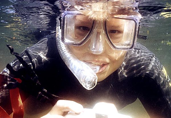 Snorkeler wearing a clear silicone diving mask