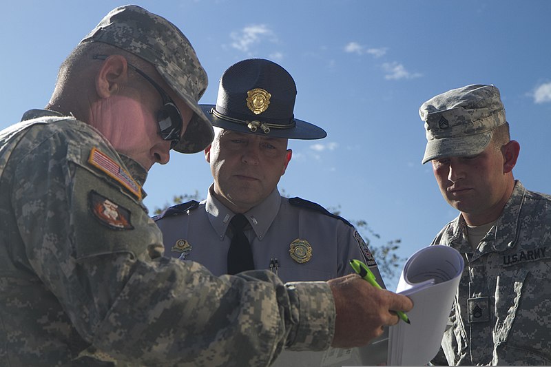 File:U.S. Army Lt. Shawn Stankus, with Troop 3 of the South Carolina Highway Patrol, reviews an exercise plan with U.S. Soldiers assigned to the 1050th Transportation Battalion, South Carolina National Guard before 131102-Z-DH163-010.jpg