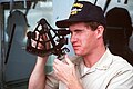 A midshipman takes a sextant reading aboard the frigate USS Badger (FF 1071).