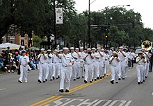 U.S. Navy band marches in the 2008 parade. US Navy 080809-N-9056L-053 Sailors from Navy Band Great Lakes march in the 79th annual Bud Billiken parade, kicking off the 2008 Chicago Navy Week events.jpg