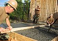 US Navy 091022-N-2571C-042 Seabees use a long board to screed wet concrete.jpg