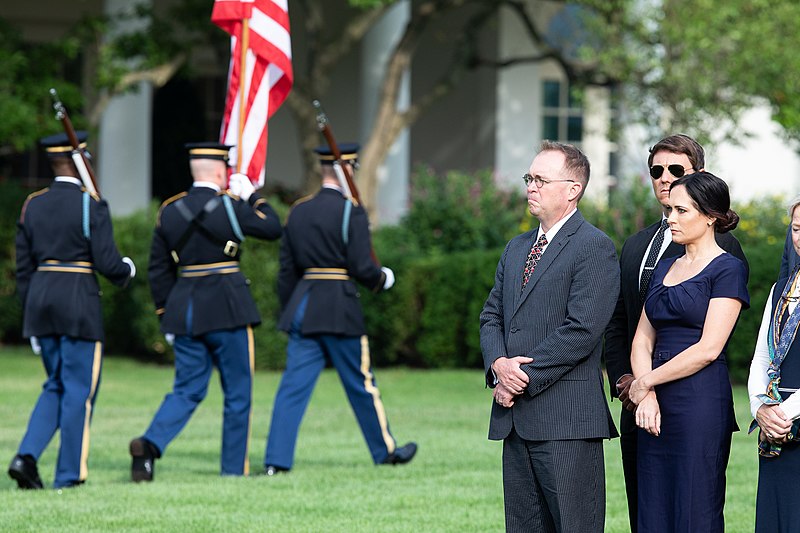 File:White House Chief of Staff Mick Mulvaney and White House Press Secretary Stephanie Grisham look on as the Color Guard prepares to post the colors for a moment of silence on the South Lawn (48717846121).jpg
