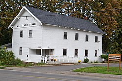 Photograph of the Willakenzie Grange Hall, a 2-story, gabled, wooden structure