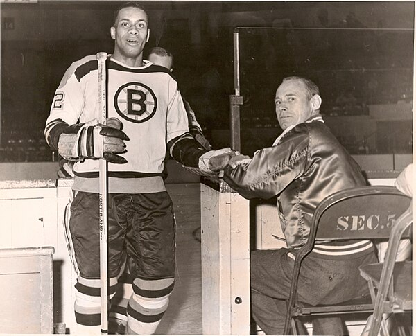 Willie O'Ree of the Boston Bruins and Detroit Red Wings trainer Len "Johny" Fletcher, 1961