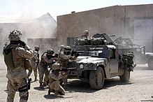 U.S. Marines from 1st Battalion, 5th Marines fire at insurgent positions during the First Battle of Fallujah. 1-5 Marines in Fallujah 07 April 204.jpg