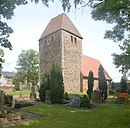 Cemetery with village church, churchyard wall and war memorial