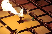 Australian legend Louise Sauvage lights the Paralympic Cauldron at the finish of the torch relay, 2000 Summer Paralympics Opening Ceremony. 201000 - Opening Ceremony athletics competitor Louise Sauvage flame lighting 6 - 3b - 2000 Sydney opening ceremony photo.jpg