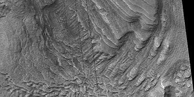 Tilted layers, as seen by HiRISE under HiWish program. Location is Hellas quadrangle.