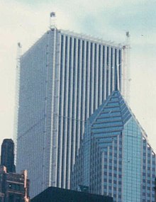 Aon Center in the 1990s during its refacing, with temporary work elevators erected in the building's corners Aon Center during resurfacing with temporary work elevators in its corners (22427576248) (1).jpg