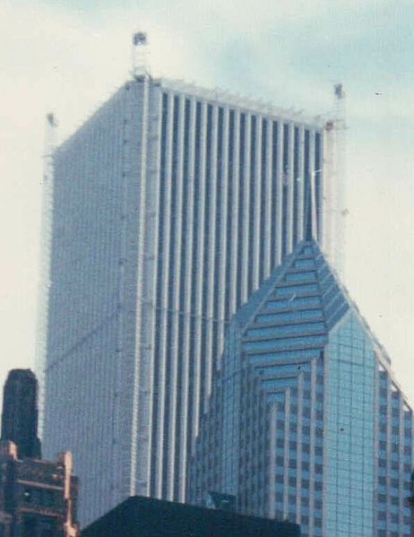 Aon Center in the 1990s during its refacing, with temporary work elevators erected in the building's corners