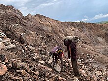 Revenue from mineral exports makes up a large portion of the Democratic Republic of Congo's economy. While Congo is rich in mineral resources, these deposits require extensive manual labor to extract, often under life-threatening conditions. Mining of cobalt is tied to human rights abuses, such as unsafe worksites, child labor, and forced Congolese labor, in addition to environmental degradation. Artisanal cobalt miners in the Democratic Republic of Congo.jpg