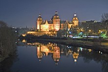 Schloss Johannisburg reflected in the river Main at night