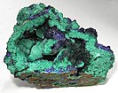 Vug with rosettes of deep blue azurite on a field of malachite
