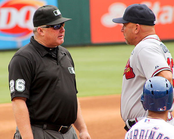 Miller (left) discusses a call during a 2014 game with Atlanta Braves manager Fredi Gonzalez