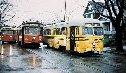 Two Cincinnati streetcars in April 1951, a week before streetcar service ended. Streetcars were replaced by trolleybuses (one of which is seen behind the streetcars).