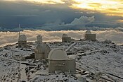 La Silla Observatory blanketed in snow as the Sun sets.[51]
