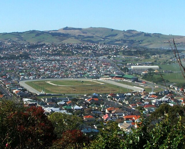 Looking across Forbury Park and southern Saint Kilda from the west. The large white building in the upper right of the picture is Dunedin Ice Stadium,