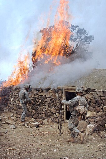 US soldiers burning a suspected Taliban safehouse in March 2007