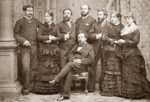 Cast of the fourth version premiere at the Politeama Genovese, 1879. Left to right: Francesco Marconi, Flora Mariani De Angelis, Gialdino Gialdini, Ed