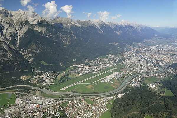 Aerial view of the airport and its surrounding mountains.