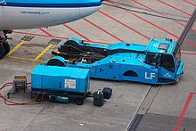 KLM Pushback tractor and a ground power unit KLM Pushback tractor and ground power unit.jpg