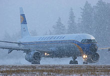 A Lufthansa Airbus A321 in a special retro livery taxiing in snow at Arlanda