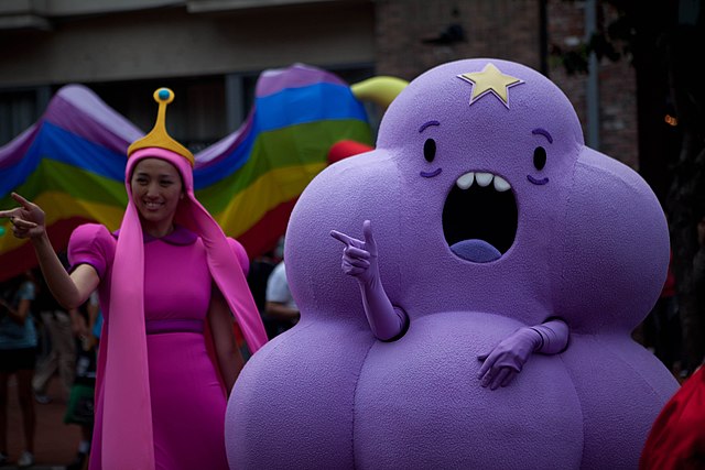 Adventure Time fans cosplaying as Princess Bubblegum (left) and Lumpy Space Princess (right)
