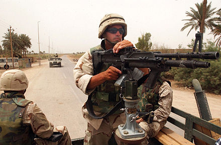 A mounted Mk 43 Mod 0 (M60E4) (later model) is crewed by a Seabee of NMCB-15 (Naval Mobile Construction Battalion), on a convoy in Iraq in May 2003.