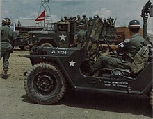 Military Police stop traffic to allow the 2 1/2 ton trucks carrying members of the Black Panther Division to leave Newport Docks, enroute to Bearcat, 22 July 1968 MPs escort Black Panther Division, July 1968.jpg