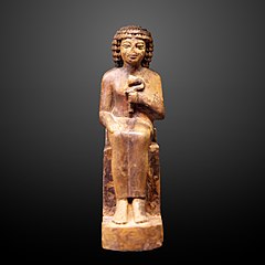 Seated man holding a nenufar-N 1581