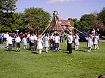 Children dancing around a maypole as part of a May Day celebration in Welwyn, England Maypole Dancing on Village Green - geograph.org.uk - 1628839.jpg