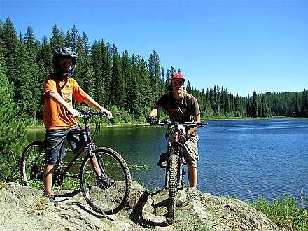 Mountain bikers stop at 2nd Champion Lake outside the Village of Fruitvale near Greater Trail