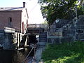 The swing-gated underpass of the O'Donnell Bridge, running adjacent to the Pawtucket Gatehouse. This is where the Merrimack River gets diverted into the Northern Canal of the Lowell Canal System. Located near the the southeast end of the O'Donnell Bridge in Lowell, Massachusetts.