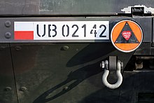 Visibly painted-on plate reading UB02142 on a military transporter.