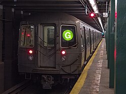 View of the end of a southbound "G" train at the elevated Smith-Ninth Streets station. The train consists of cars with the contract name R68.